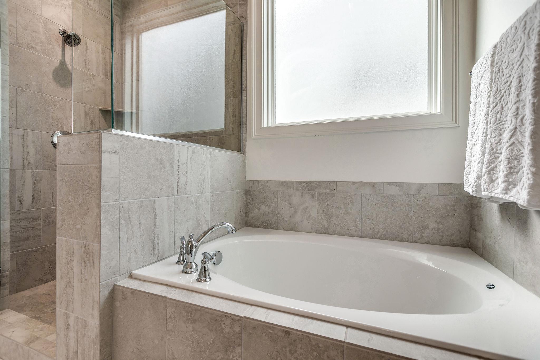 537 Alfred Ladd Road East Franklin, TN 37064 - Photo 16 of 28 Large bathtub with tile surround and tiled shower.