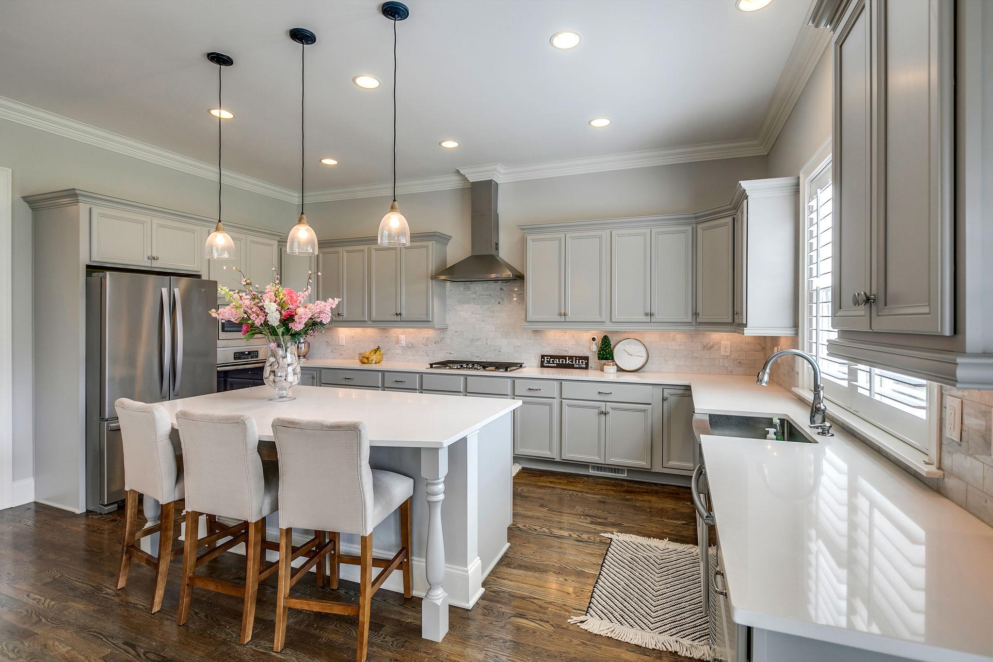 537 Alfred Ladd Road East Franklin, TN 37064 - Photo 8 of 28 Designer kitchen with island, quartz countertops, marble backsplash, and large walk-in pantry.