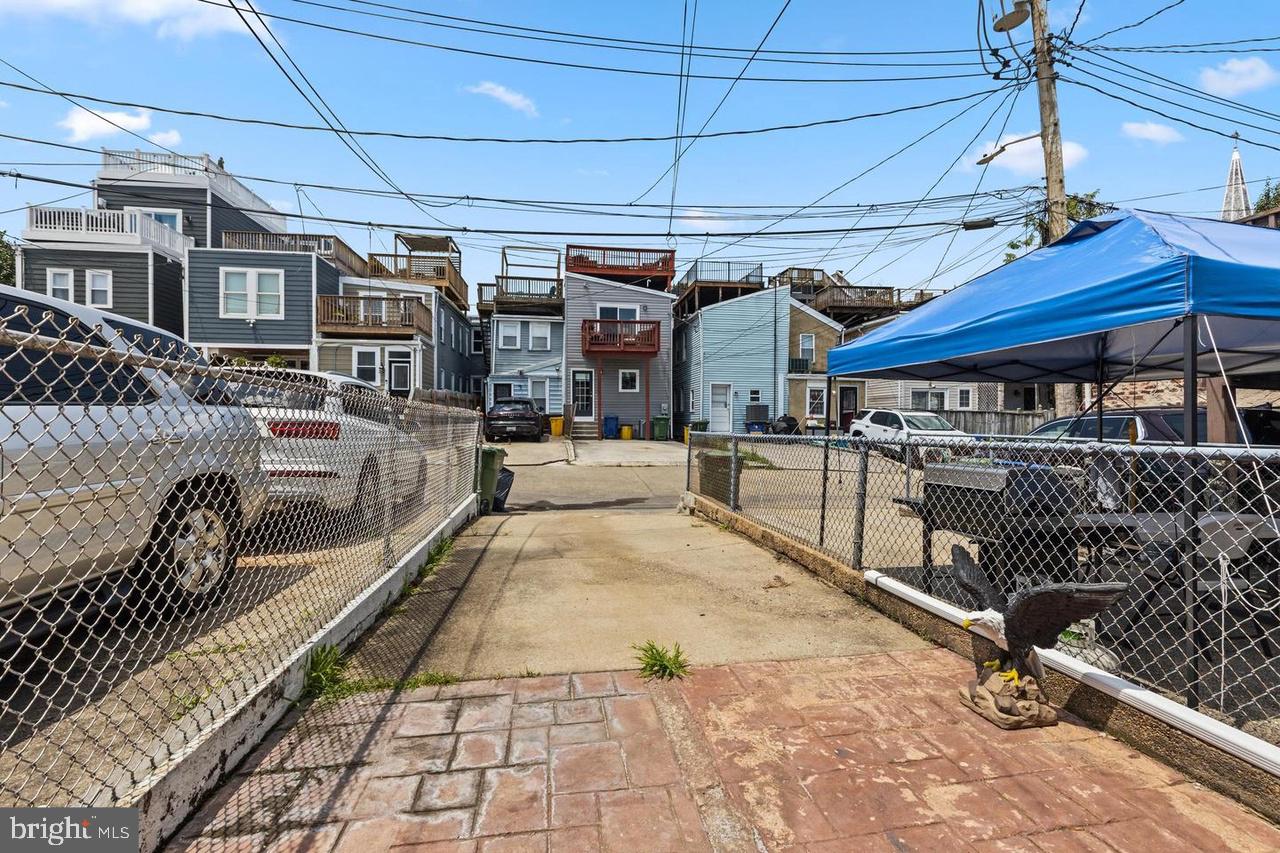 1444 Henry Street Baltimore, MD 21230 - Photo 18 of 18 Charming alleyway with vibrant homes.