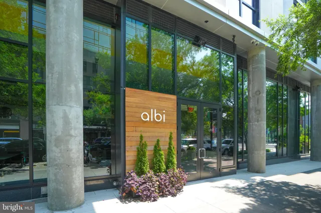 a view of a lake with table and chairs next to an ocean