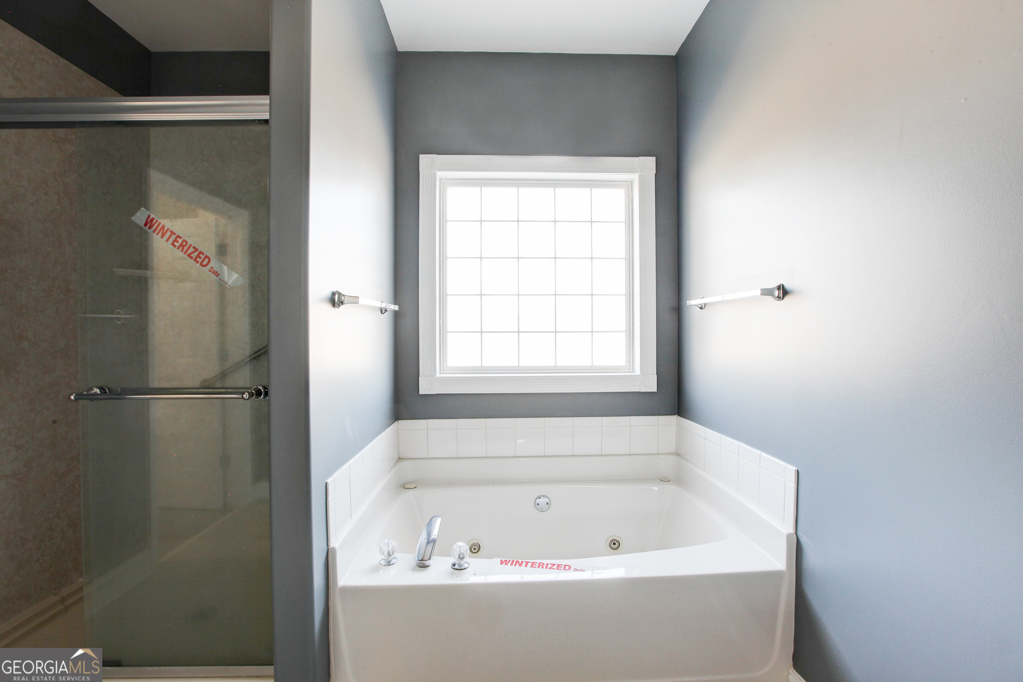 500 Soho Place Locust Grove, GA 30248 - Photo 11 of 26 a white bath tub sitting next to a window
