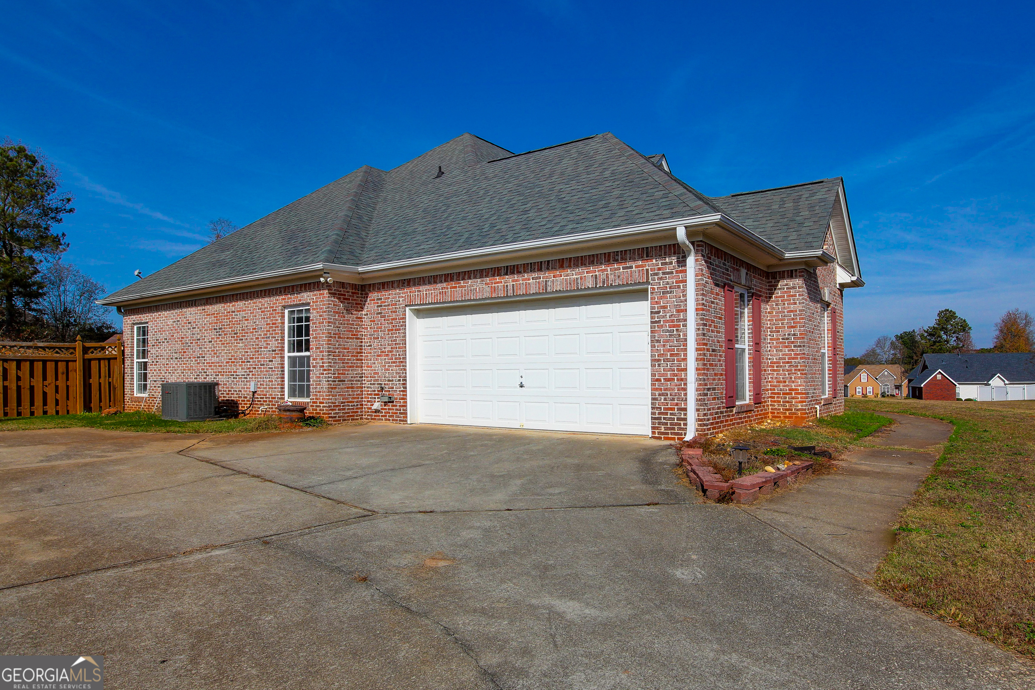 500 Soho Place Locust Grove, GA 30248 - Photo 2 of 26 a front view of a house with a yard and garage