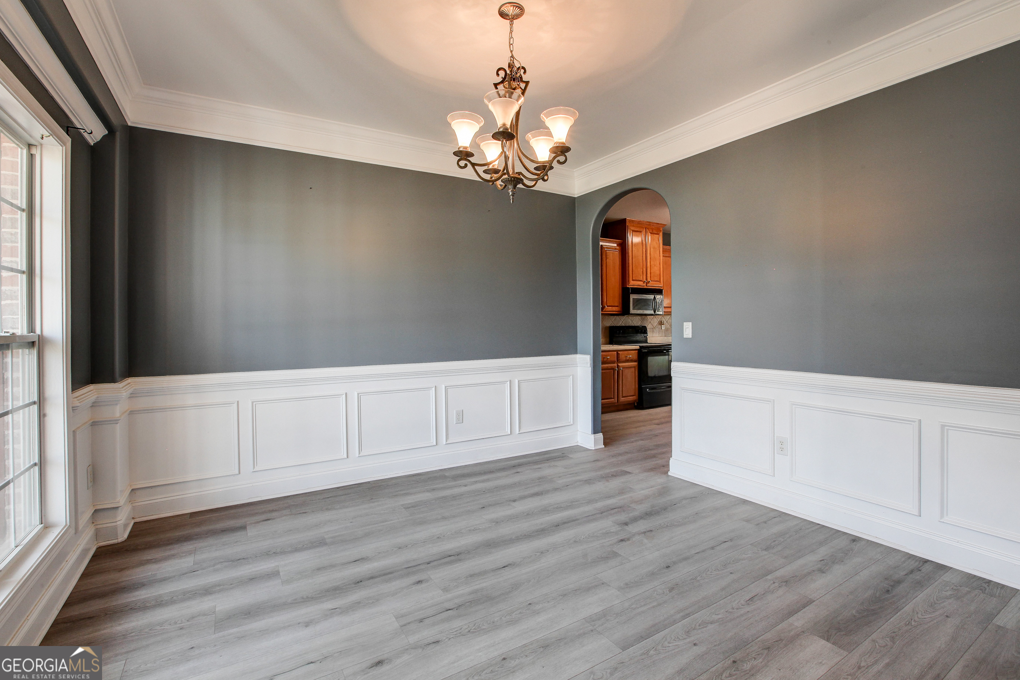 500 Soho Place Locust Grove, GA 30248 - Photo 6 of 26 a view of a kitchen with wooden floor and a refrigerator