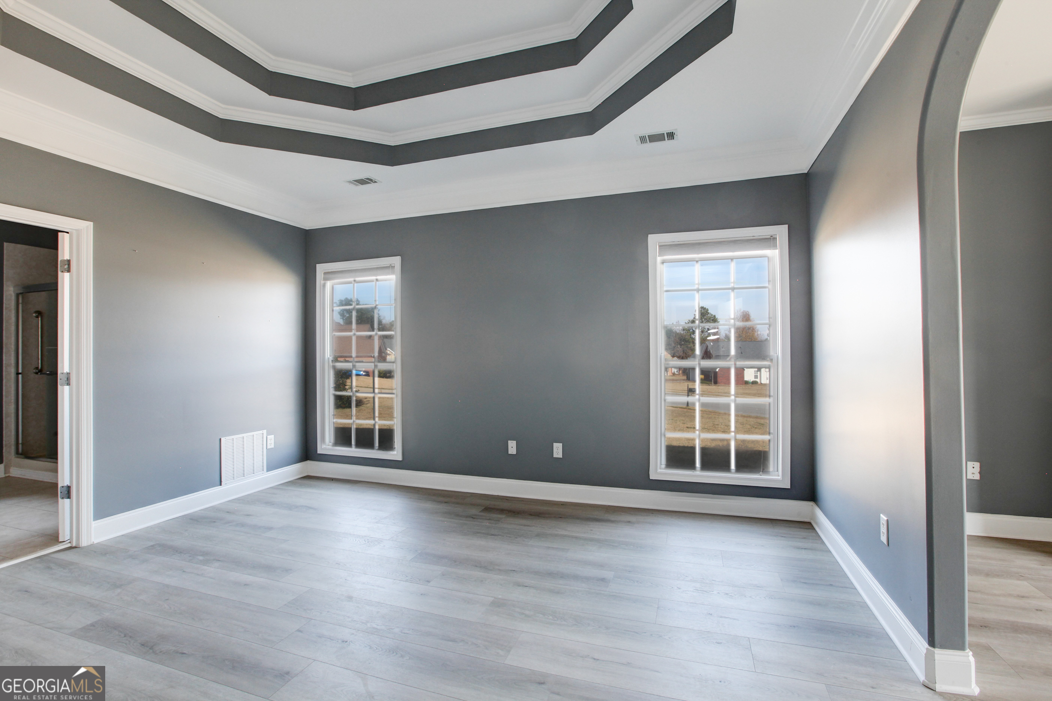 500 Soho Place Locust Grove, GA 30248 - Photo 8 of 26 a view of an empty room with wooden floor and windows