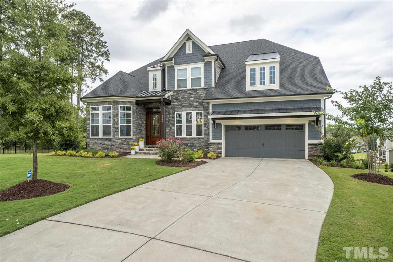 7504 Pinaster Place Raleigh, NC 27613 - Photo 1 of 30 a front view of a house with a yard and garage