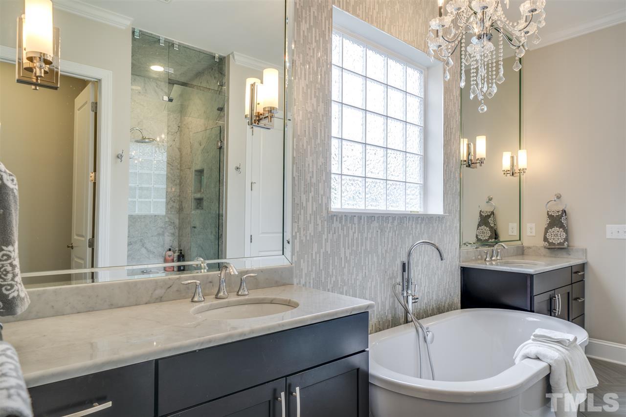 7504 Pinaster Place Raleigh, NC 27613 - Photo 14 of 30 a bathroom with a sink toilet a mirror and shower