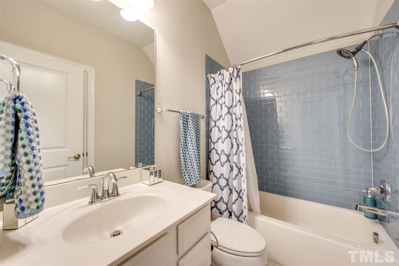 7504 Pinaster Place Raleigh, NC 27613 - Photo 16 of 30 a bathroom with a sink toilet and shower