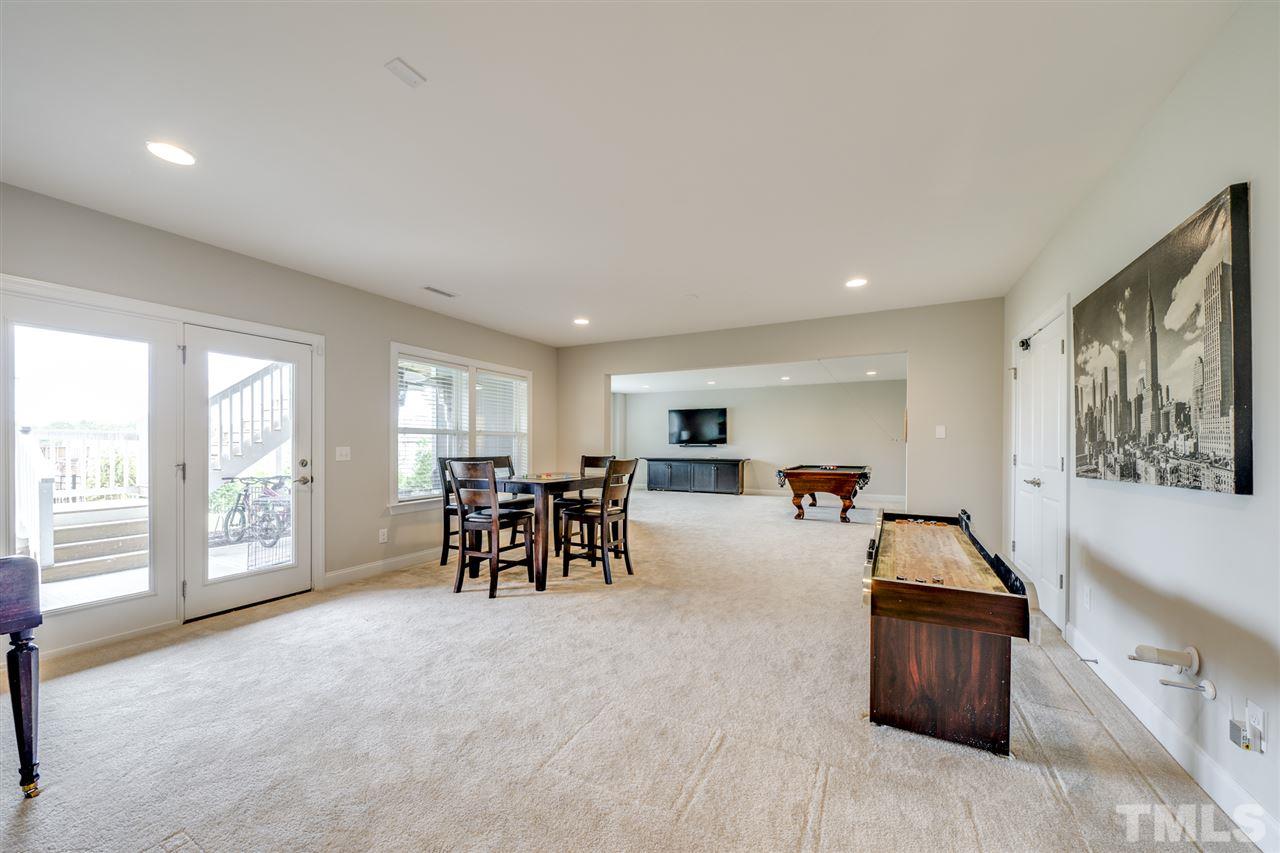 7504 Pinaster Place Raleigh, NC 27613 - Photo 23 of 30 a living room with furniture and a large window