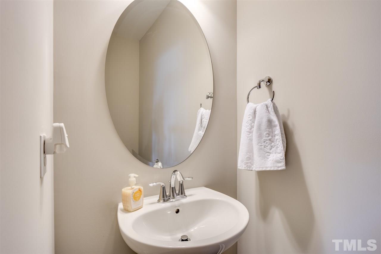 7504 Pinaster Place Raleigh, NC 27613 - Photo 25 of 30 a bathroom with a sink and a mirror