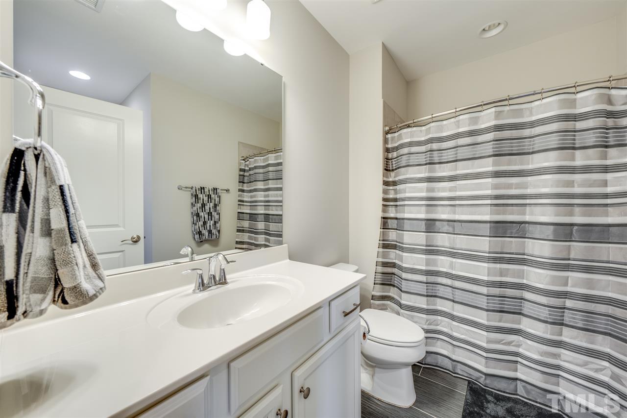 7504 Pinaster Place Raleigh, NC 27613 - Photo 26 of 30 a bathroom with a sink a toilet and mirror