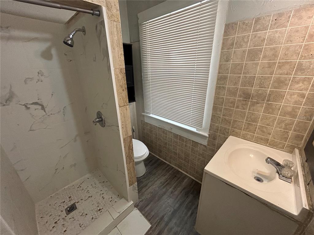 612 26th Street West, Unit 1 4 Bradenton, FL 34205 - Photo 3 of 8 a bathroom with a sink a toilet and shower