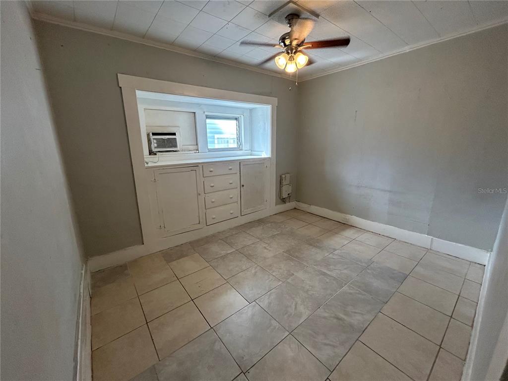 612 26th Street West, Unit 1 4 Bradenton, FL 34205 - Photo 6 of 8 an empty room with windows and fan