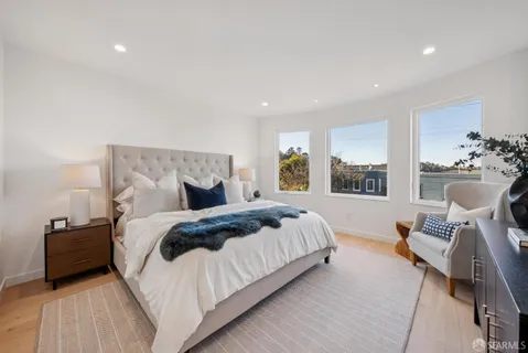 a bedroom with a bed and a couch