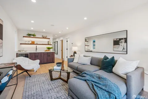 a view of a sink a mirror with wooden floor