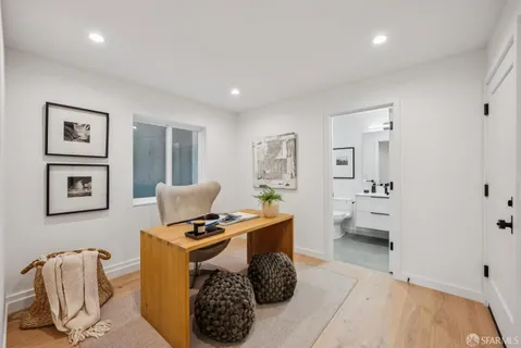 a bathroom with a granite countertop sink toilet a mirror and shower