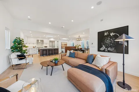 an open kitchen with dining table and chairs
