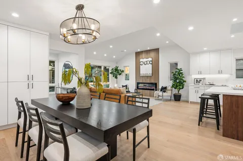 a view of a dining room with furniture and chandelier