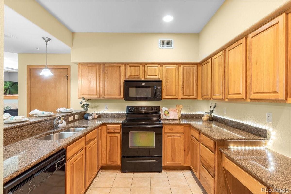 140 Sterling Loop, Unit 202 Fraser, CO 80442 - Photo 12 of 24 a kitchen with a sink stove and cabinets