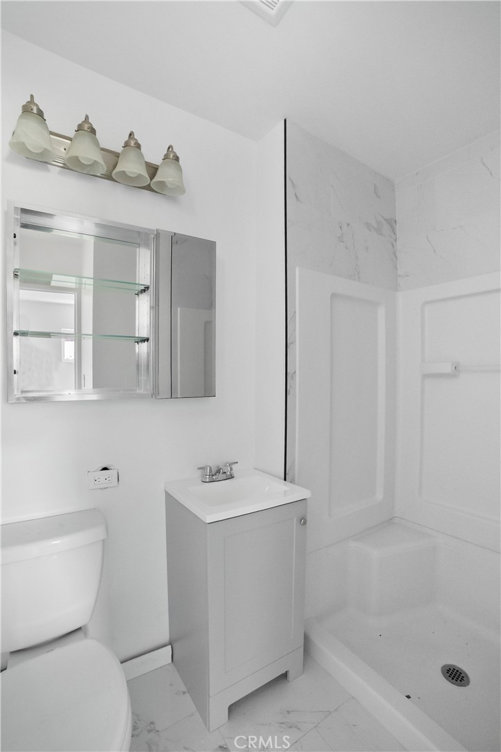 20554 Valerio Street Winnetka, CA 91306 - Photo 12 of 12 a bathroom with a sink a toilet and shower