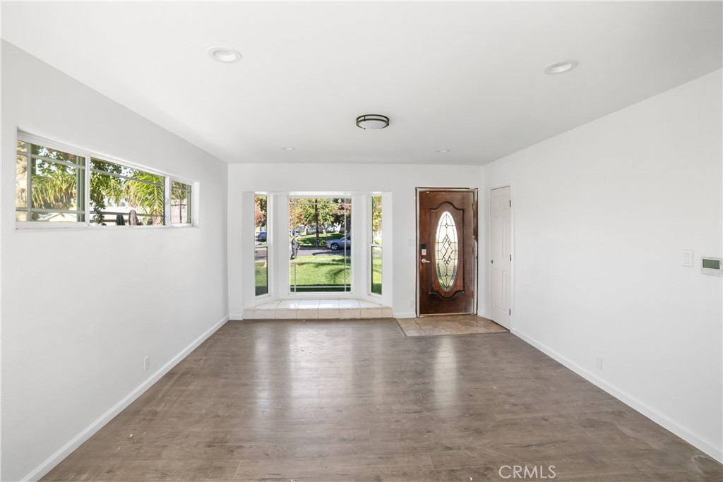 20554 Valerio Street Winnetka, CA 91306 - Photo 3 of 12 a view of an empty room with wooden floor and a window