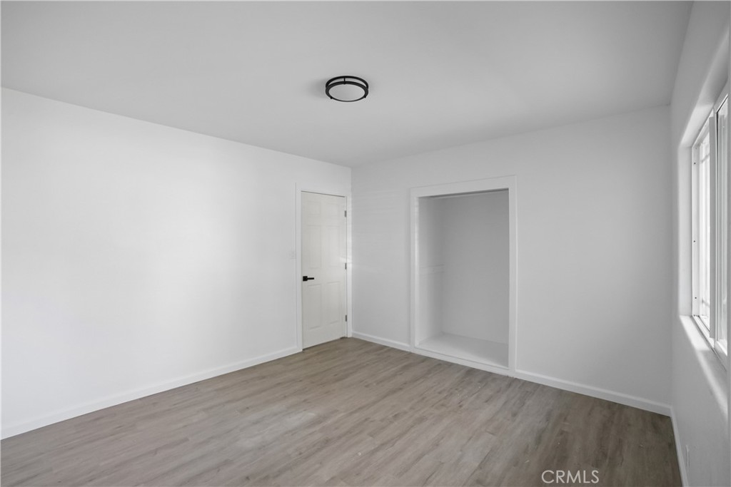 20554 Valerio Street Winnetka, CA 91306 - Photo 8 of 12 a view of an empty room with wooden floor and a window
