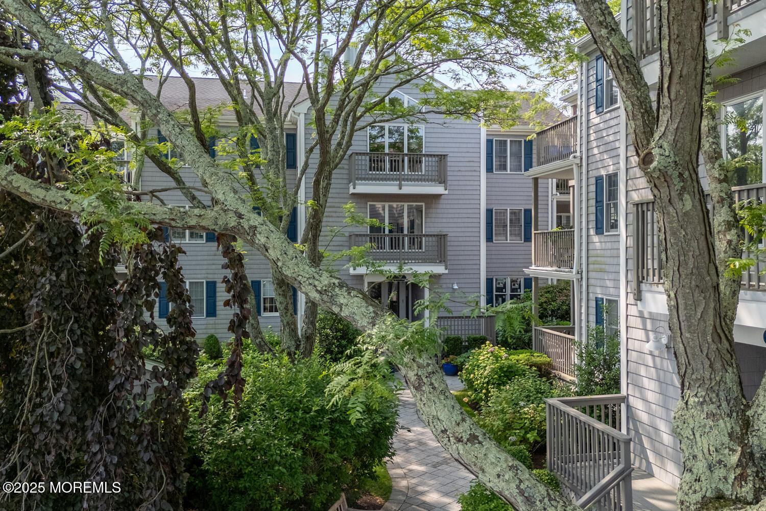 93 Bay Point Harbour Point Pleasant, NJ 08742 - Photo 2 of 49 front view of a brick house with a large trees