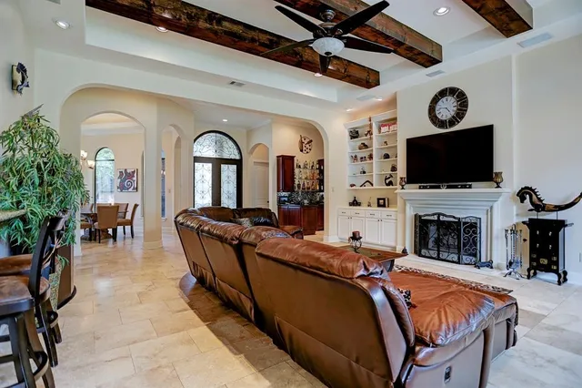a living room with fireplace furniture and a flat screen tv