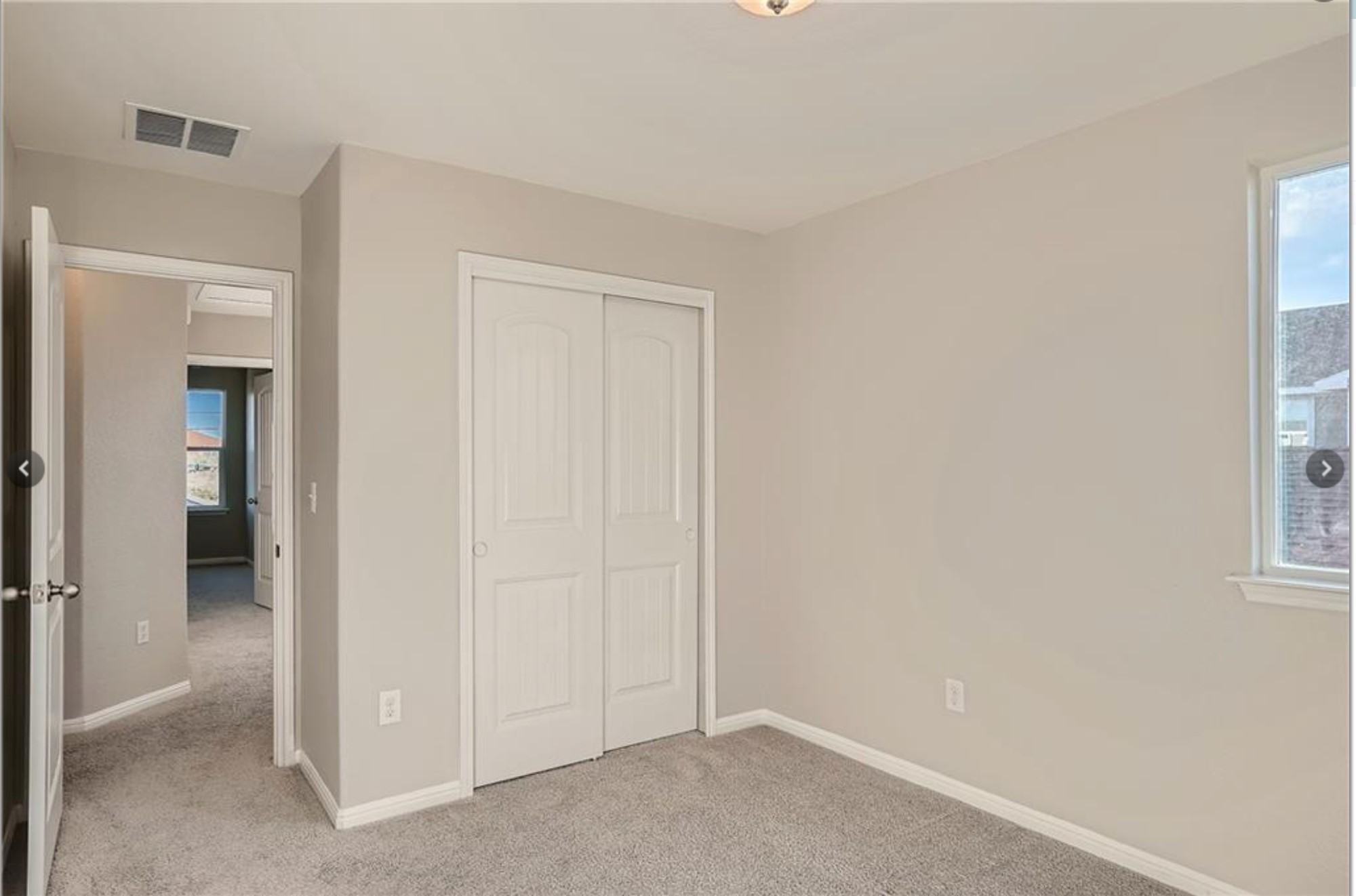 304 Cane River Road Pflugerville, TX 78660 - Photo 23 of 31 A well-lit room offering a neutral canvas for personalization, featuring plush carpeting and a large window.