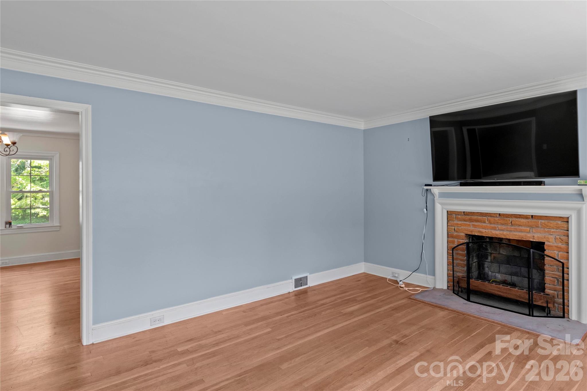 951 Dodson Mill Road Pilot Mountain, NC 27041 - Photo 9 of 48 a view of empty room with wooden floor and fireplace