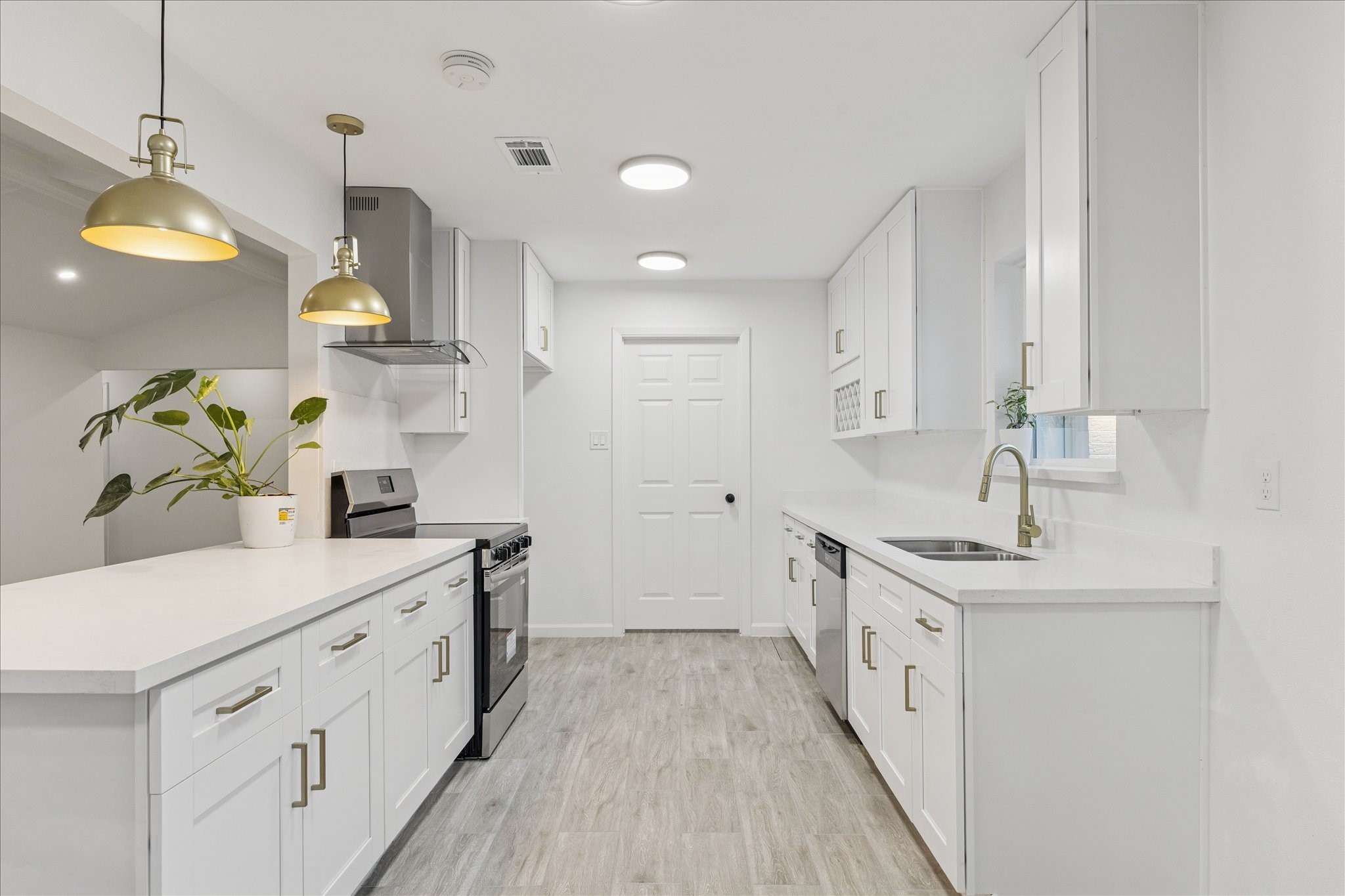 5411 Logston Lane Spring, TX 77389 - Photo 12 of 34 a kitchen with kitchen island granite countertop a sink a counter space and cabinets