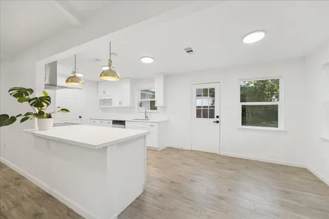 a kitchen with a sink a stove and cabinets