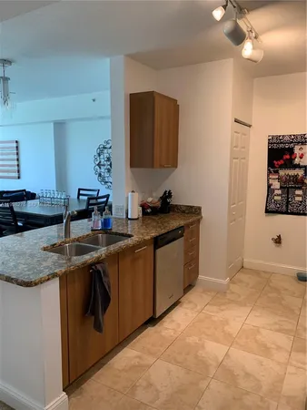 a kitchen with stainless steel appliances granite countertop a sink and a stove