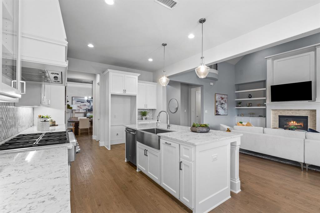 4003 Marble Hill Road Frisco, TX 75034 - Photo 12 of 40 a kitchen that has a lot of cabinets in it and wooden floors