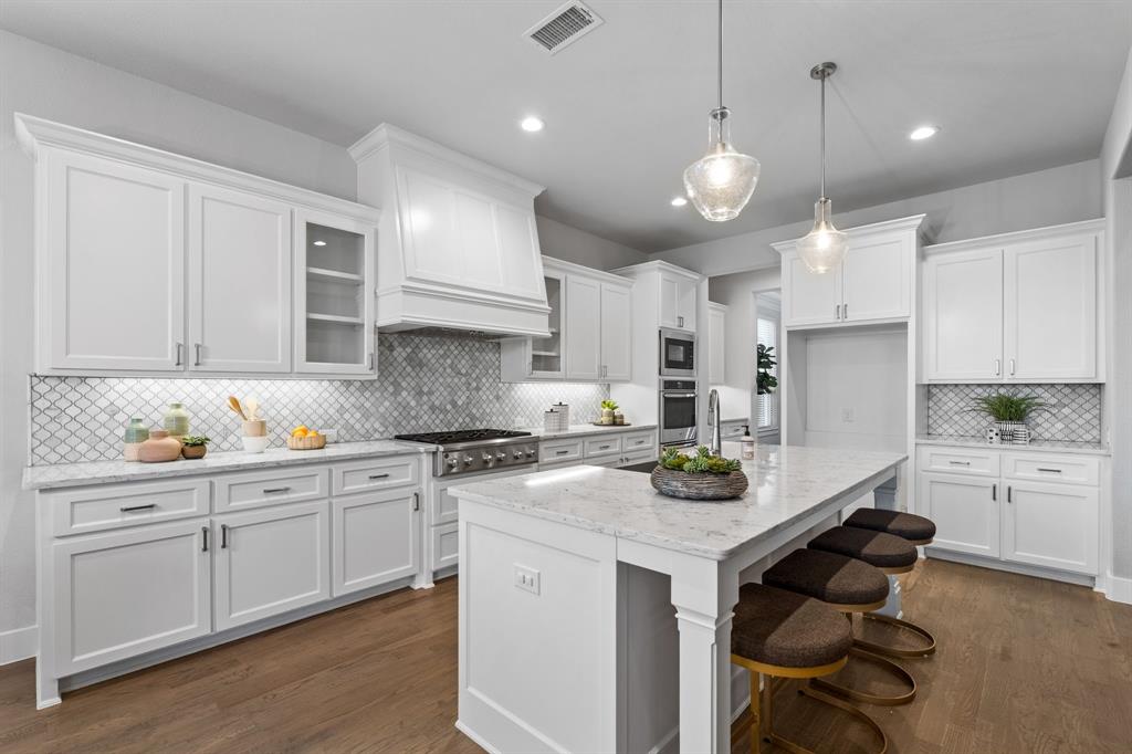 4003 Marble Hill Road Frisco, TX 75034 - Photo 13 of 40 a kitchen with white cabinets and stove
