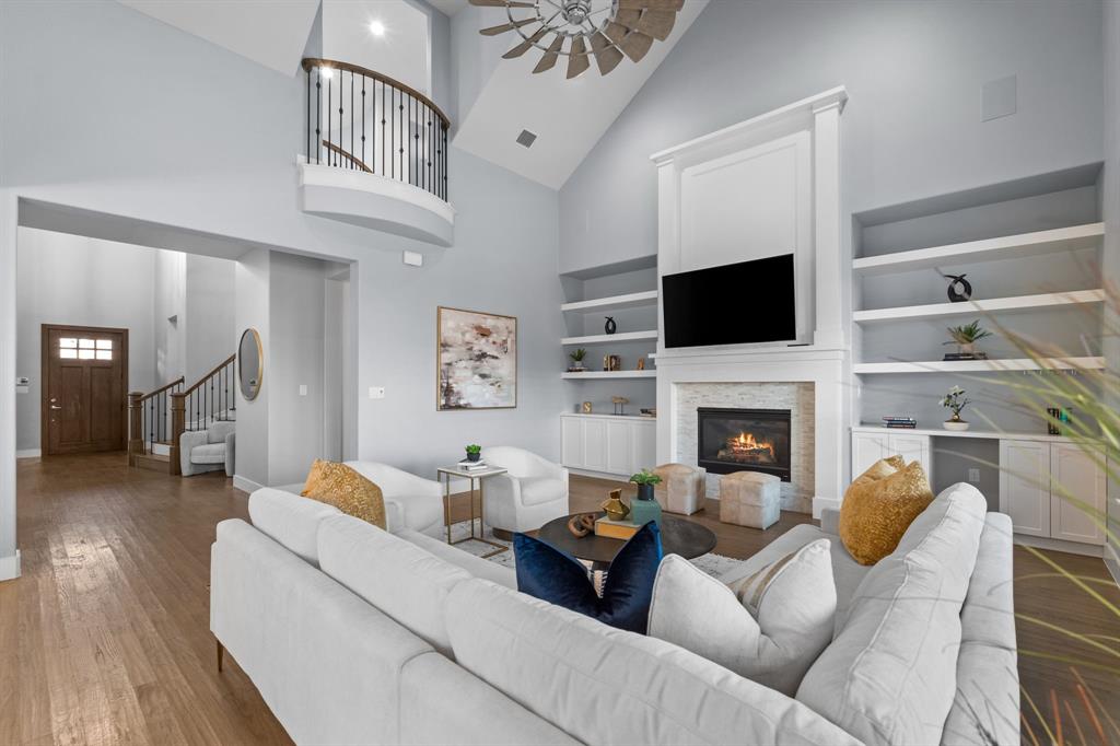 4003 Marble Hill Road Frisco, TX 75034 - Photo 18 of 40 a living room with furniture a fireplace and a flat screen tv