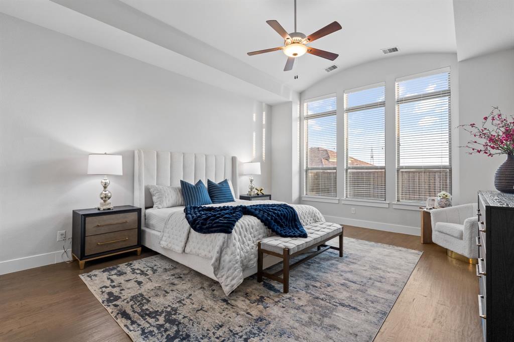 4003 Marble Hill Road Frisco, TX 75034 - Photo 19 of 40 a spacious bedroom with a bed a chandelier and a window