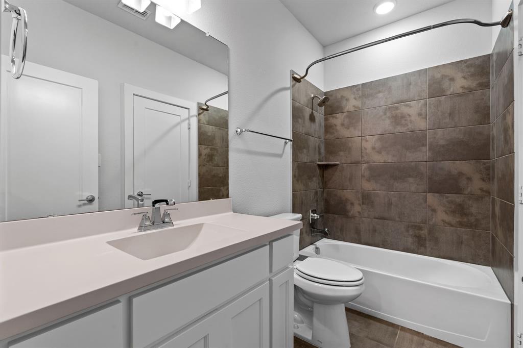 4003 Marble Hill Road Frisco, TX 75034 - Photo 31 of 40 a bathroom with a sink a toilet and shower