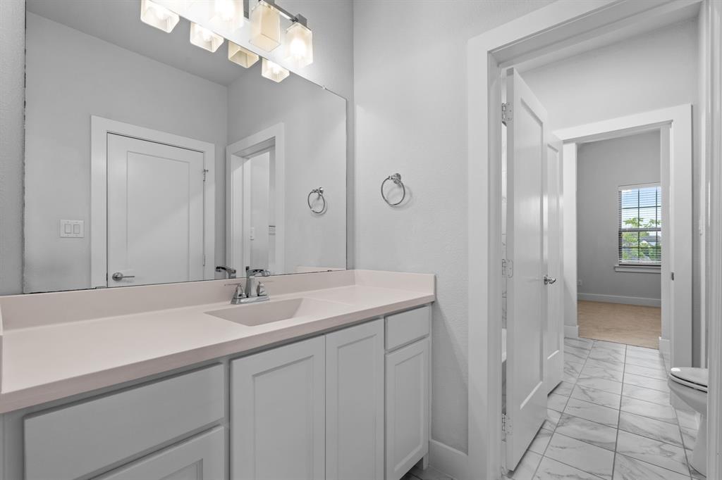 4003 Marble Hill Road Frisco, TX 75034 - Photo 32 of 40 a bathroom with a sink a vanity and a mirror