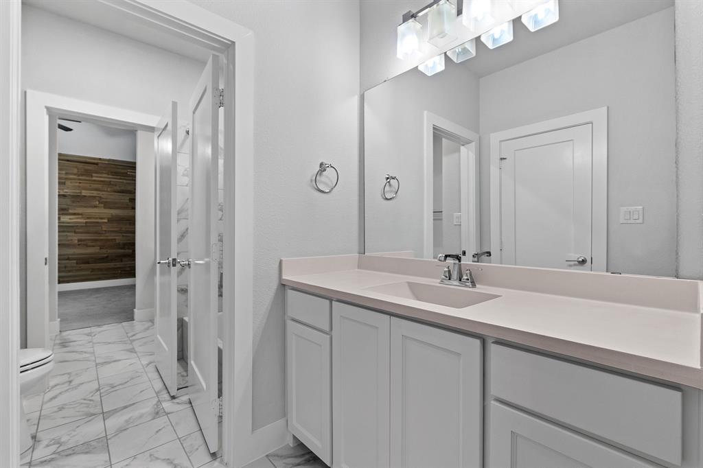 4003 Marble Hill Road Frisco, TX 75034 - Photo 34 of 40 a bathroom with a sink a vanity and a mirror