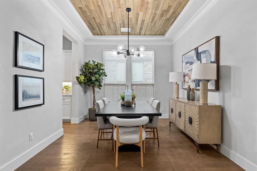 4003 Marble Hill Road Frisco, TX 75034 - Photo 7 of 40 a dining room with furniture a chandelier and wooden floor