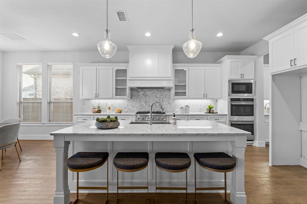 4003 Marble Hill Road Frisco, TX 75034 - Photo 9 of 40 a kitchen with granite countertop white cabinets and refrigerator