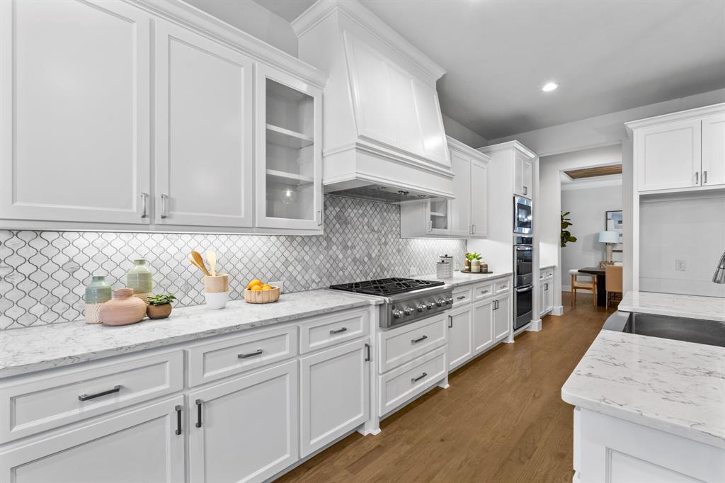 4003 Marble Hill Road Frisco, TX 75034 - Photo 10 of 40 a kitchen with granite countertop cabinets and stainless steel appliances