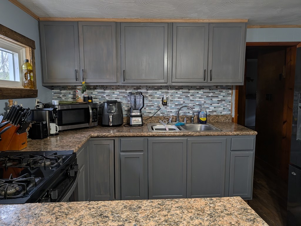 283 Nebraska Road Tionesta, PA 16353 - Photo 2 of 10 a kitchen with stainless steel appliances a sink stove and cabinets