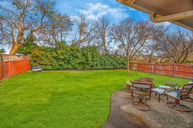 a yard with some trees in front of it