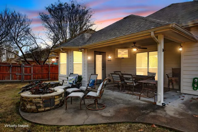 a view of a patio with couches table and chairs and potted plants