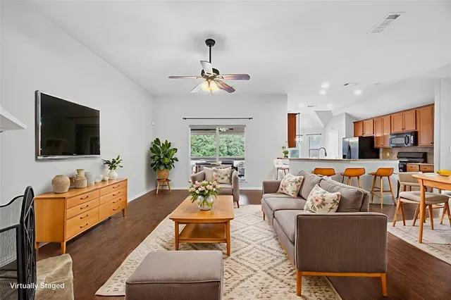 a living room with fireplace furniture and a flat screen tv