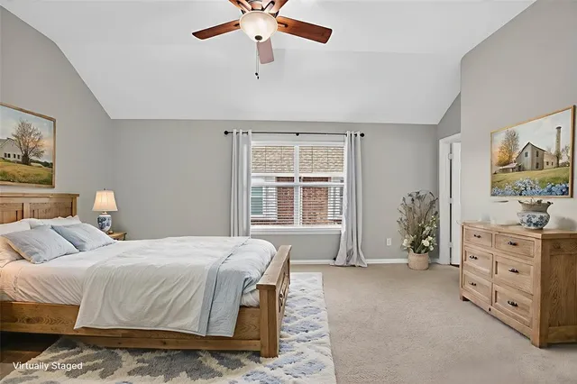 a bedroom with a large bed and a window