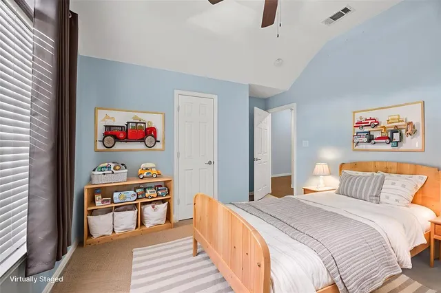 a bedroom with bed and wooden floor