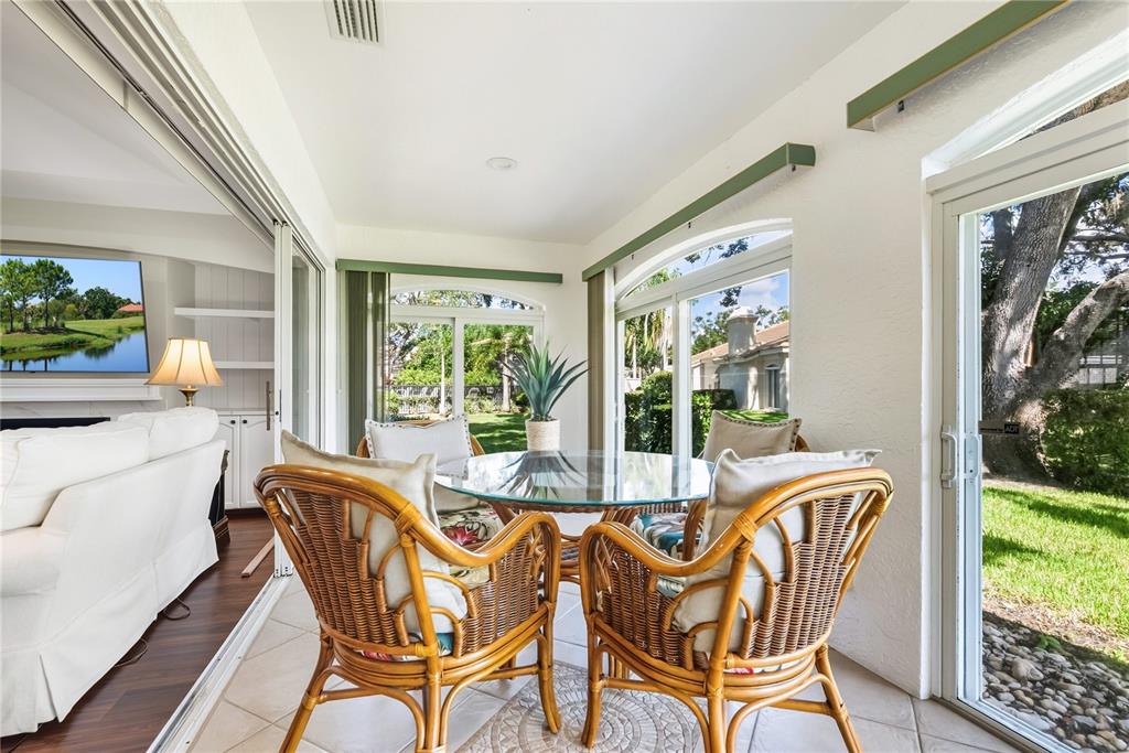4016 Oakley Greene, Unit 40 Sarasota, FL 34235 - Photo 12 of 51 a view of a dining room with furniture a chandelier and wooden floor