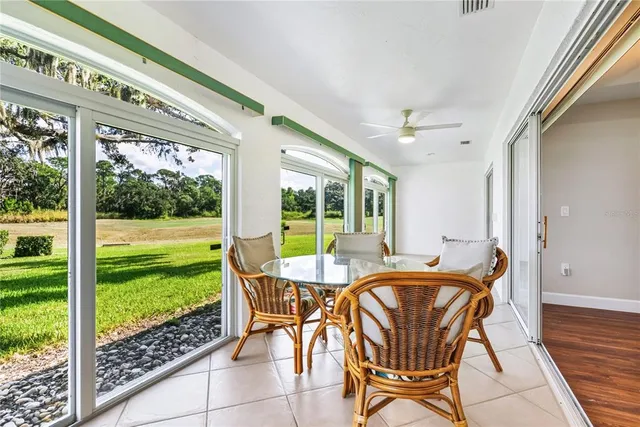 a view of a house with a big yard plants and large trees